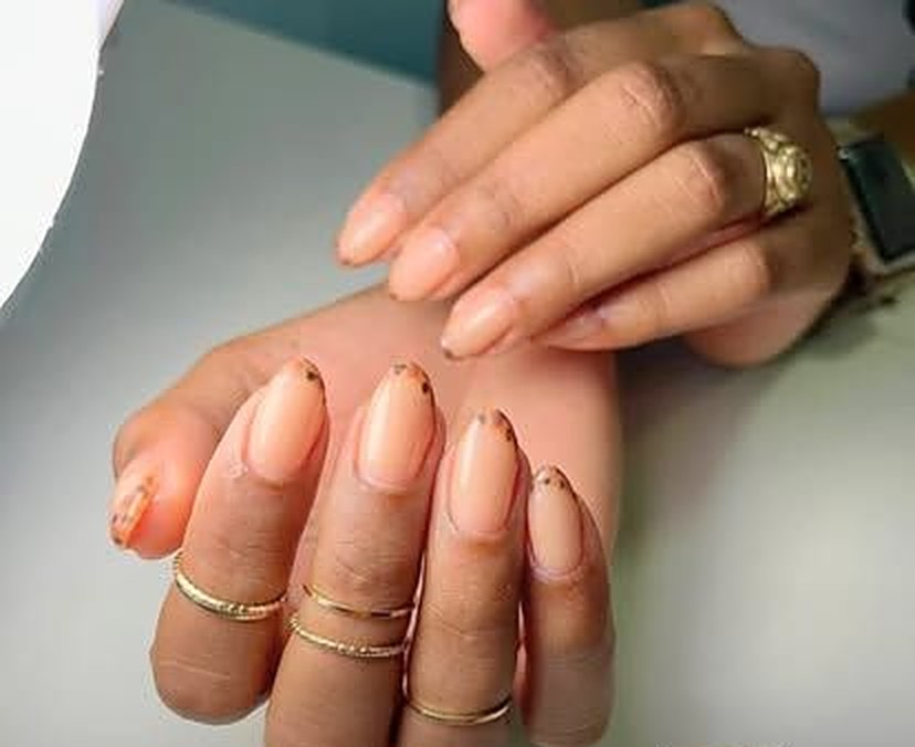 Short almond nails in a soft peachy nude with tiny gold cuticle accents — Relax Manicure at Viva Nail Spa