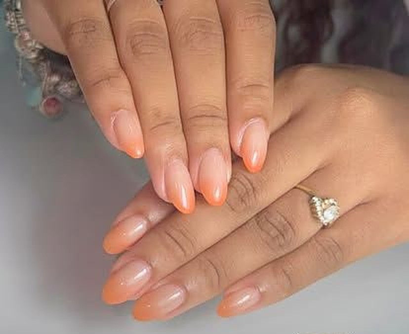 Almond nails in a glossy peach to nude ombre fade, done at Viva Nail Spa